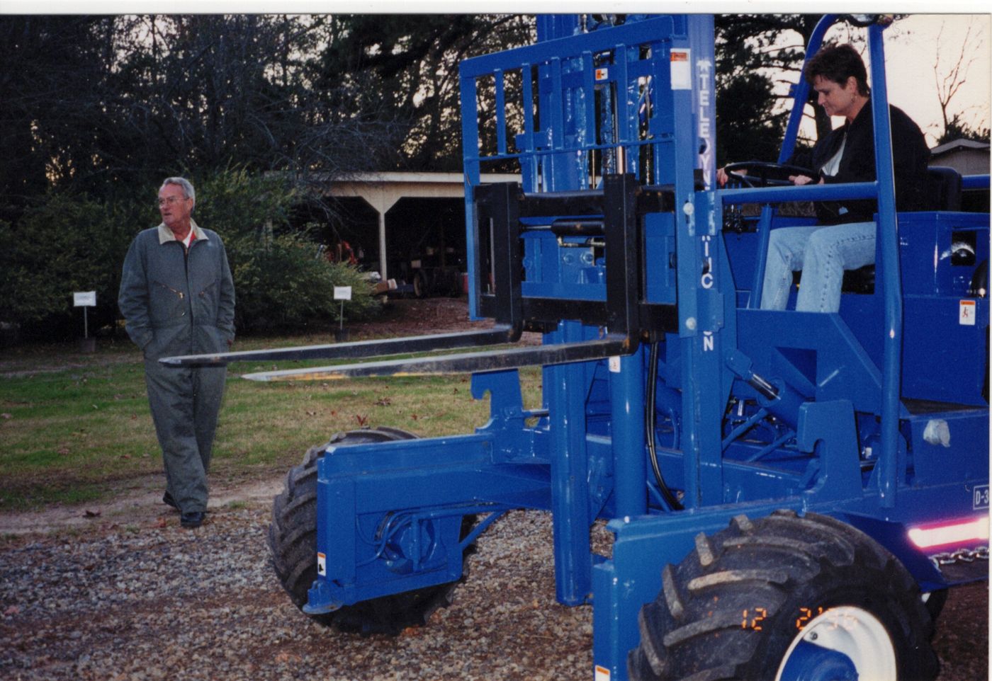 Bobby watching as his new Princeton Piggyback forklift is test driven in the yard